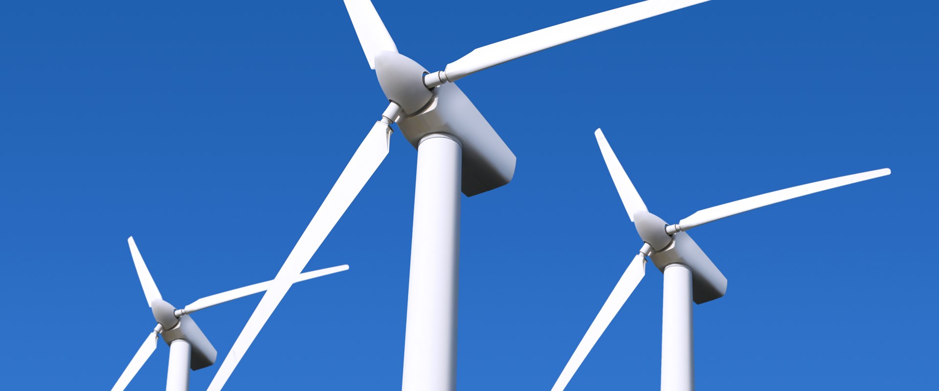 Wind farm turbines in blue sky background